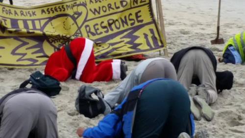 Santa took time out of his schedule to take part in #HeadsInSandNZ in Dunedin yesterday. Photo: Metiria Turei MP 